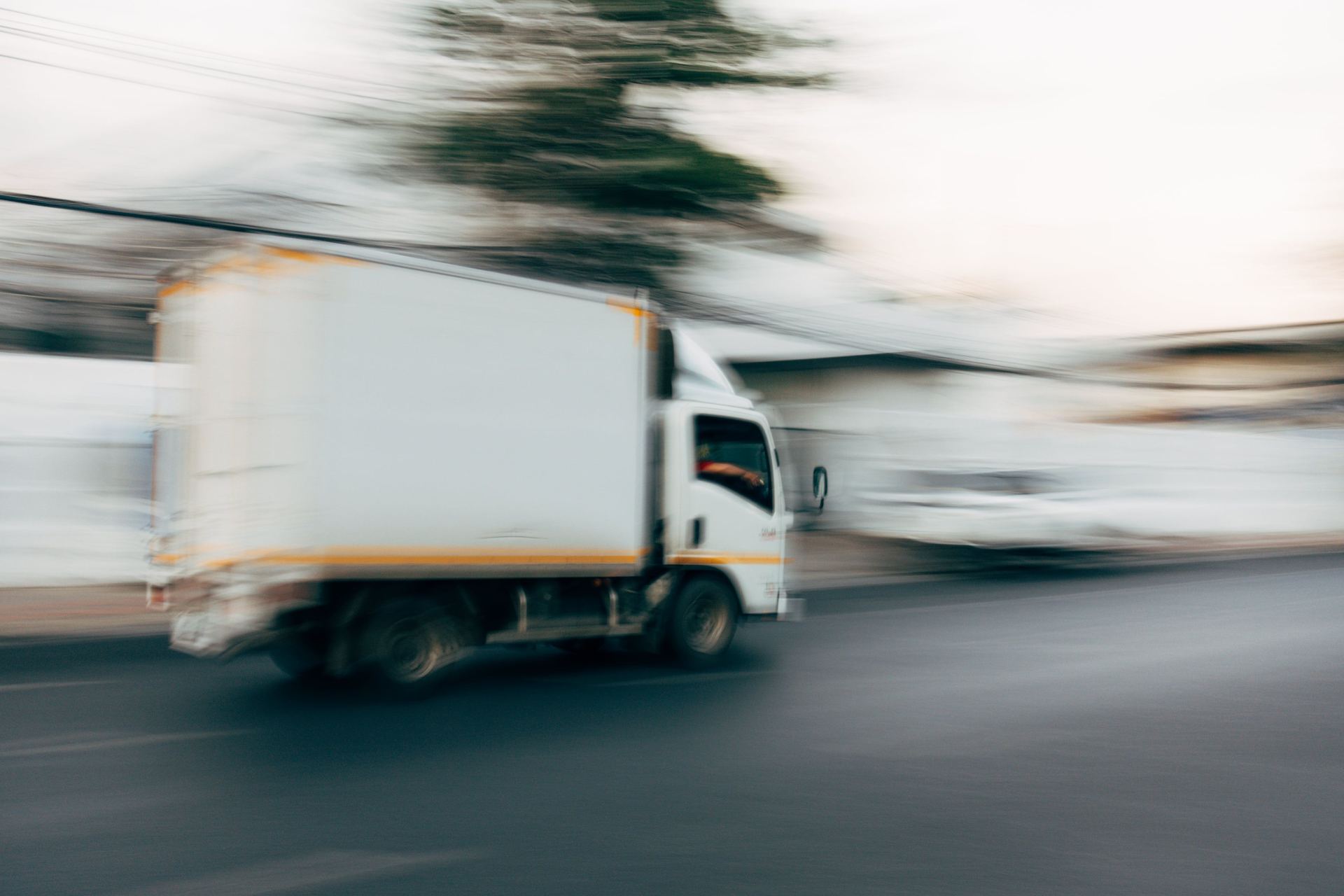 White box truck moving through traffic